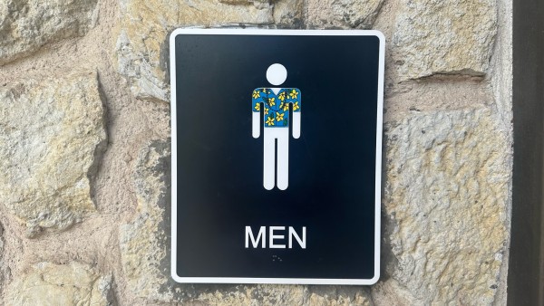 Mens room sign with a Hawaiian shirt sticker over the figure