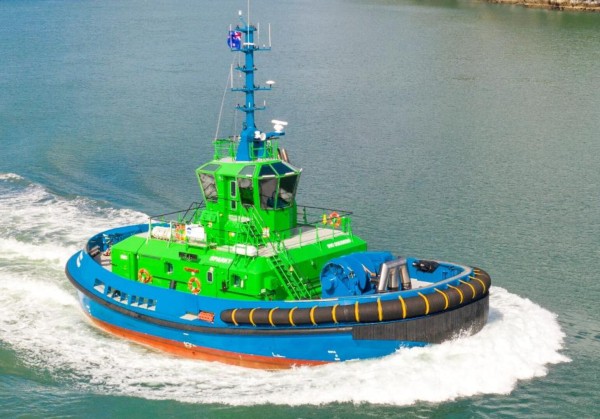 real photo of a tiny tug boat with blue and hot green paint scheme