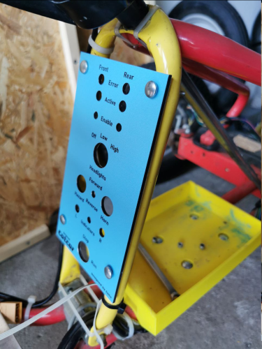 blue control panel preliminarily mounted to a yellow metal rod which is part of my kart