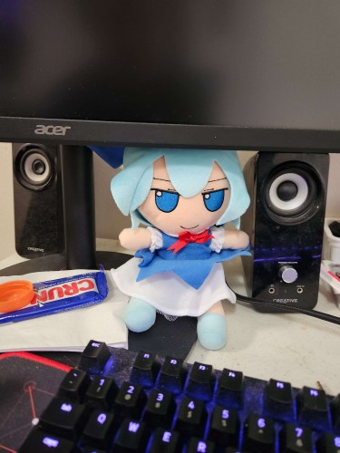 Cirno being a baka under my primary monitor, she is next to my speaker and has access to chocolate