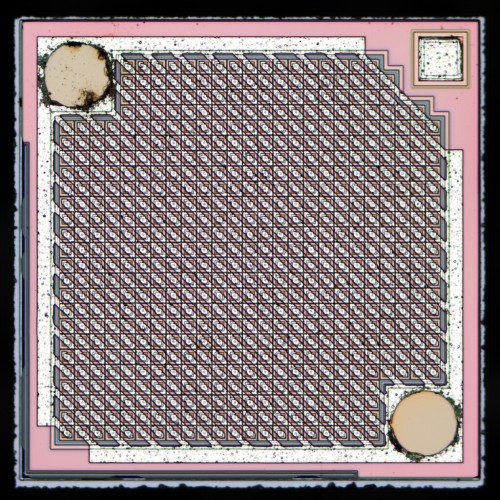 photo of the die inside a transistor that has an 25x25 array of transistors between the three pins