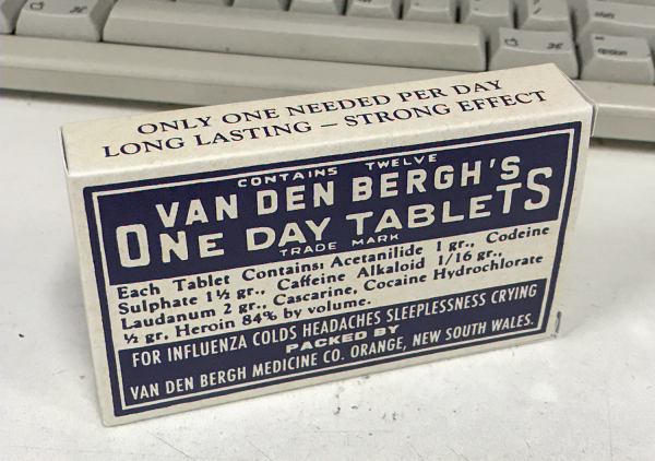 A photo of a pack of what looks like medication from the early 1900s. Across the top it states "ONLY ONE NEEDED PER DAY LONG LASTING STRONG EFFECT". On the front, "Contains twelve van den bergh's one day tablets trade mark. Each tablet contains acetanilide 1 grain, codeine sulphate one and a half grains, caffeine one sixteenth a grain, laudanum two grains, cascarine, cocaine hydrochlorate half a grain and heroin 84% by volume. FOR INFLUENZA COLDS HEADACHES SLEEPLESSNESS CRYING"