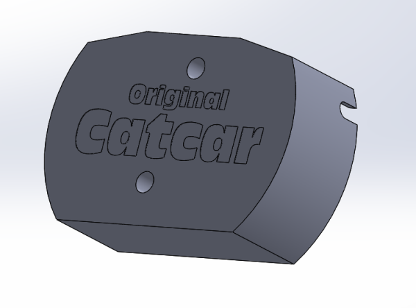 3D render of a somewhat oval shaped cover with cutouts for wires in the side. The text "Original Catcar" is embossed on the top side.