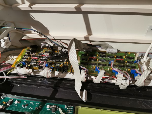 Two circuit boards next to each other, with a lot of ribbon cables going to / from them